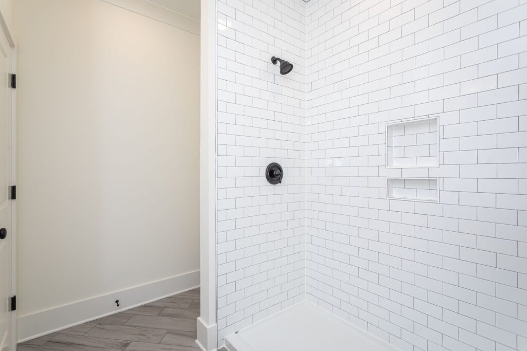 Indulge in tranquility: Step into the master bath's tiled walk-in shower.
